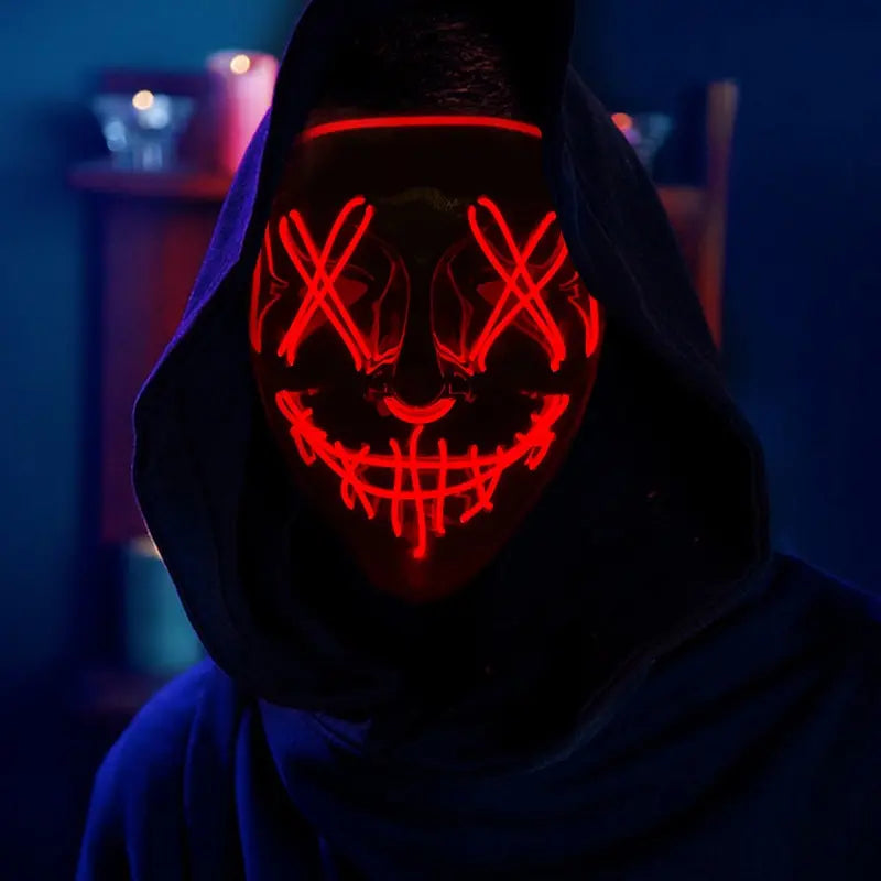 LED Purge Halloween mask glowing red worn by hooded model in the dark